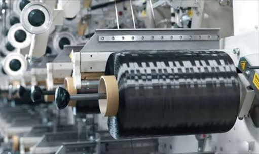 Why are composite materials widely used with glass fiber better than carbon fiber
